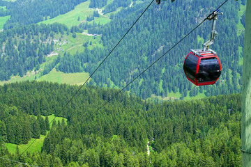 Gondola cars on steep piste to the valley