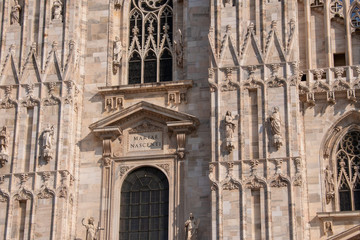 Fototapeta na wymiar the writing Marie nascenti on the front of the Duomo cathedral of Milan