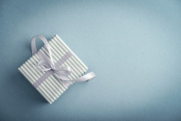 One striped  gift box with grey ribbon