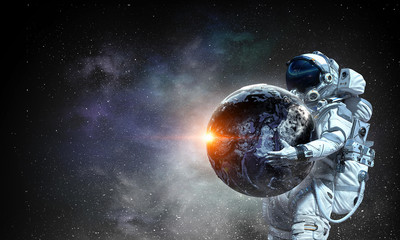 Fototapeta na wymiar Spaceman carry big planet. Mixed media
