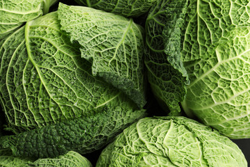Fototapeta premium Fresh green savoy cabbages as background, top view