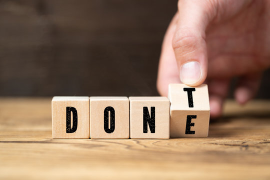 Hand turns two cubes, changing the word "don't" to "done" 