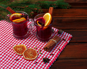 christmas hot mulled wine with cinnamon cardamom and anise on wooden background