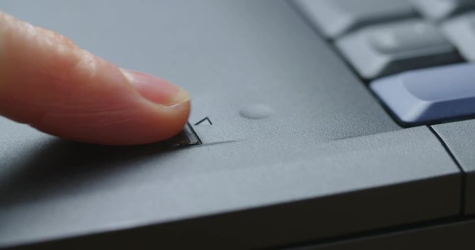 Secure access - fingerprint reader scanning a female finger for identification. Closeup shot.