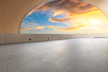 Empty floor and dramatic sky with coastline at sunset