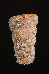 Bread coconut cone on black background