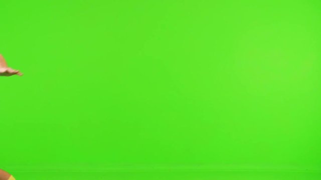 Excited Soccer player runs and celebrate a goal over a green screen, super slow motion, 4 different takes.