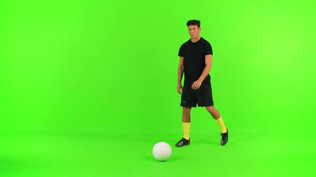 Soccer player prepares for a free kick, kicks and celebrate over a green screen.