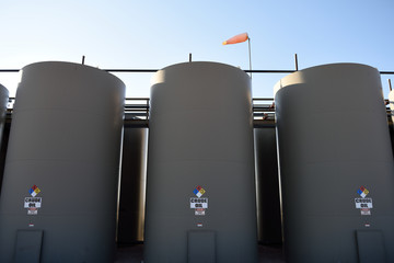 Raw crude oil production storage holding tanks in the Powder River Basin of Wyoming, USA.