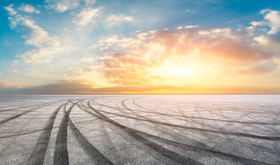 Asphalt road pavement and dramatic sky at sunset