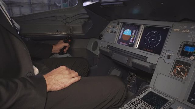 The cockpit of the aircraft. The pilot checks the steering wheel of the aircraft before takeoff. Preparation of passenger airliner for takeoff. The pilot adjusts the autopilot. 4k