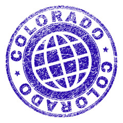 COLORADO stamp imprint with grunge texture. Blue vector rubber seal imprint of COLORADO label with corroded texture. Seal has words arranged by circle and planet symbol.