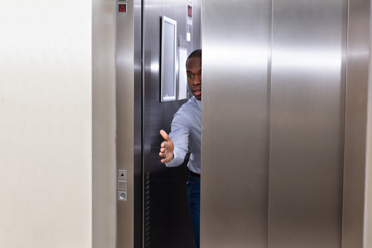 Man Trying To Stop Elevator Door
