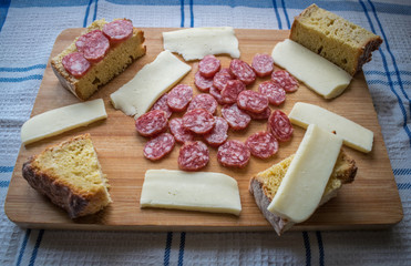 Cutting board with cheese, chorizo ​​sausage and bread is a typical spanish tapas