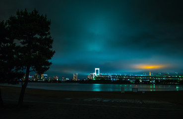 Rainbow Bridge and Skyline of Tokyo by night - beautiful view from Odaiba