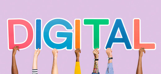 Hands holding up colorful letters forming the word digital
