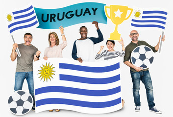 Diverse football fans holding the flag of Uruguay