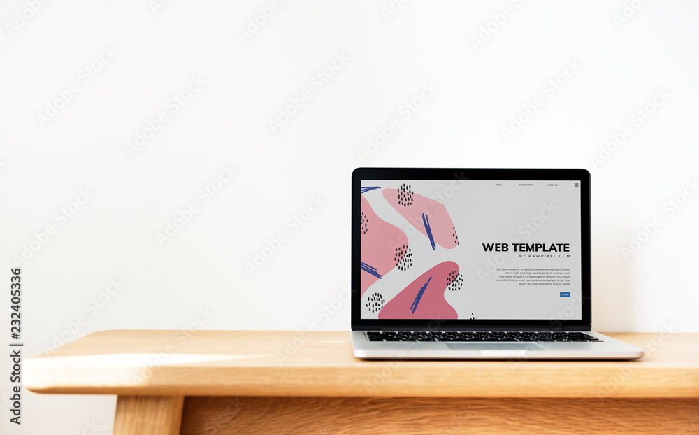 Wall mural laptop showing website template on a wooden table