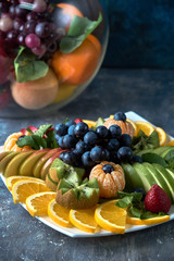fruit plate. Glass bank of lemonade with sliced citrus fruits on a buffet table