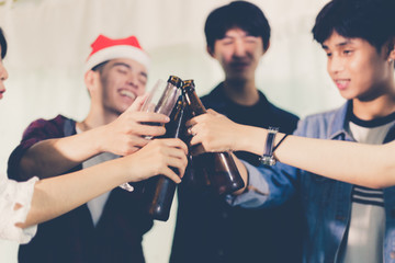Asian group of friends having party with alcoholic beer drinks and Young people enjoying at a bar toasting cocktails.soft focus