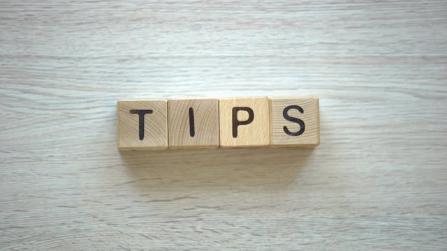 Tips, woman making word of cubes, answers to frequently asked questions, advices