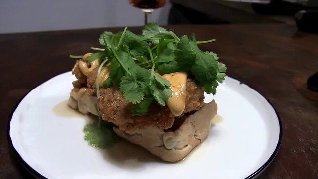 Orbeting battered and fried chicken breast on belgian waffle