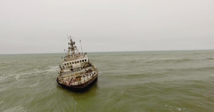 Aerial orbit, flying around Zeila shipwreck in ocean off Namibia Skeleton Coast