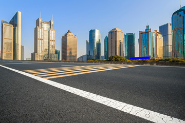 Fototapeta na wymiar City skyscrapers and road asphalt pavement