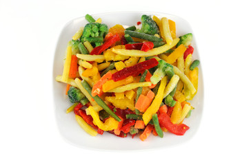 colorful frozen vegetable in the plate isolated on white background