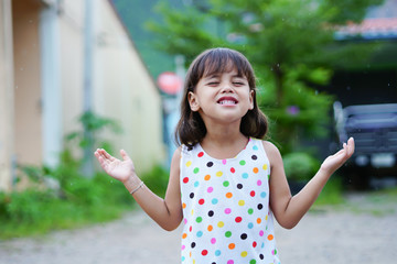 Child smiling in the rain.