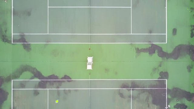 Aerial view of old Tennis court  with tennis players practicing on the court