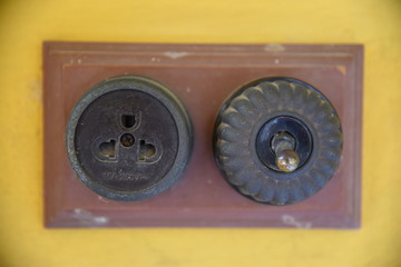 Vintage put light switch on wall. Ancient power switch.