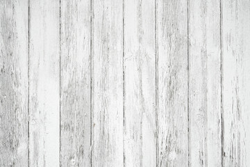 Fototapeta na wymiar Old weathered wood surface with long vertical boards. Wooden planks on a wall or floor with grain and texture. Light neutral flat faded tones.