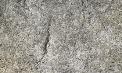 Gray and brown textured stone granite background. Flat dry stone granite rock texture with fissures and shadows.