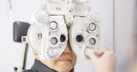 Asian old man doing eye exam