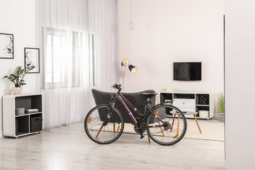 Light living room interior with modern bicycle