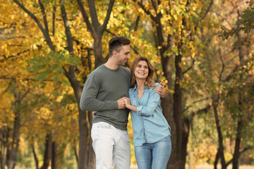 Fototapeta premium Happy lovely couple on walk in autumn park