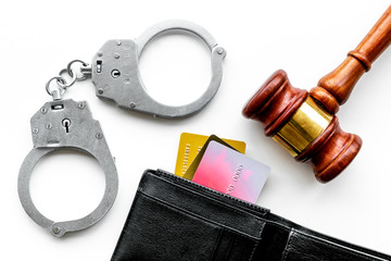 Arrest of cybercriminals, hackers concept. Handcuff near bank card and judge gavel on white...