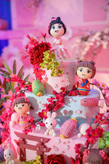 Girl child cake decoration icing sugar in close up view