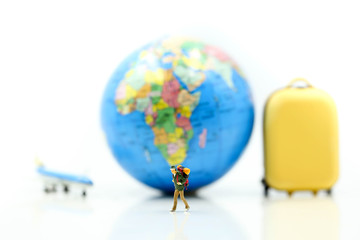 Miniature people : travelers with backpack standing on miniature baggage with world maps,travel and Saving Concept.