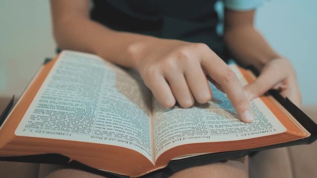 little girl holy bible prays with bible in her hands. the catholicism sacred holy bible. children and religion upbringing faith symbol. lifestyle Little girl with praying . Peace , hope, dreams