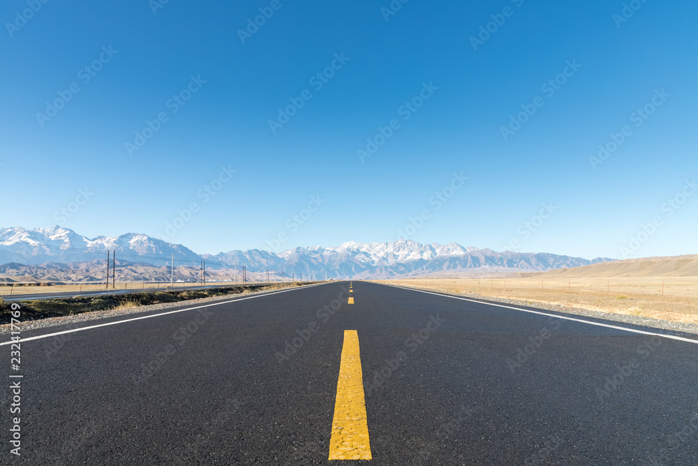 Wall mural long road on wilderness