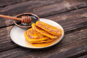 pancake with honey on wooden background
