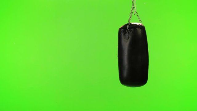 Boxing bag over a green screen.