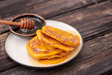 pancake with honey on wooden background