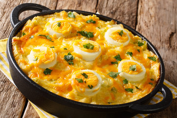 Welsh casserole Anglesey eggs baked with mashed potatoes, cheese sauce with leek close-up. horizontal
