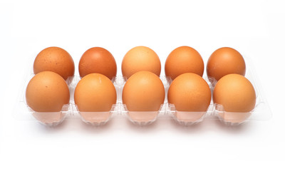Chicken eggs in plastic package on white background.