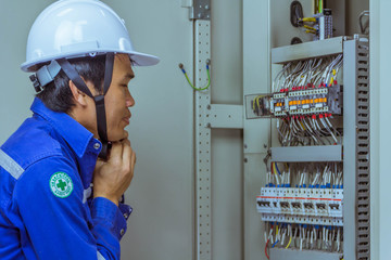 Male engineers wearing a safety helmet before checking the electrical system