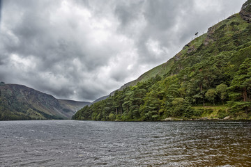 Dramatic landscape from the heart of Glendalough valley Irish Scenery. Blue sky. Wicklow National Park, Ireland