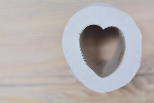 Toilet Paper In The Form Of Heart. Wooden Background.